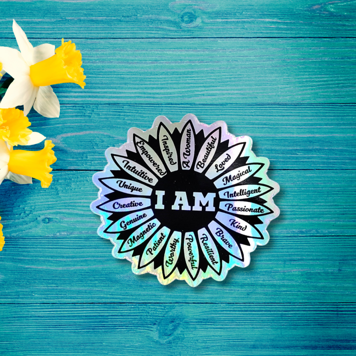 I Am affirmation text based holographic sticker on a wooden background