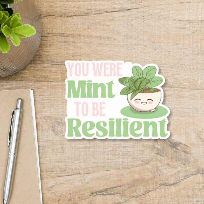 cute resilience text quote with pink and green font on a light wooden background