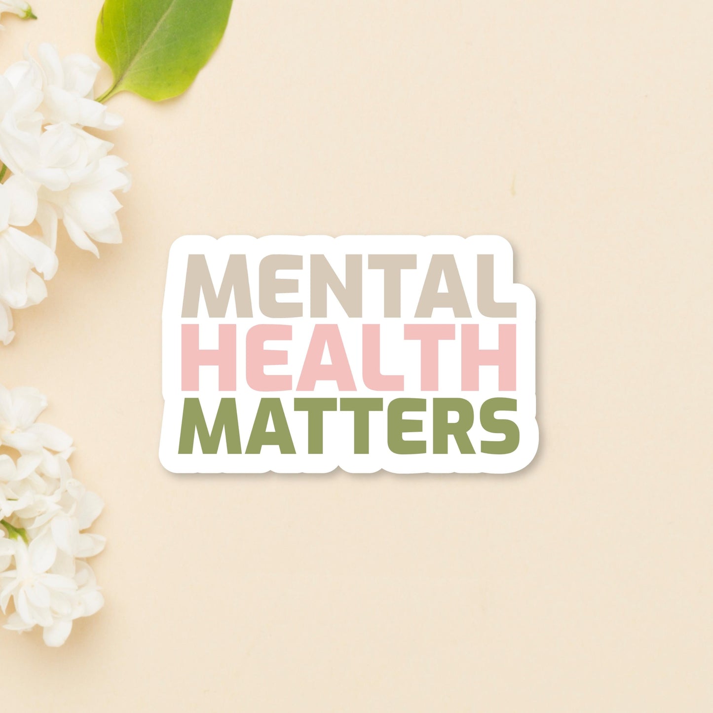 Mental Health Matters Inspirational Sticker - on tan background with white flowers on the side. Close up