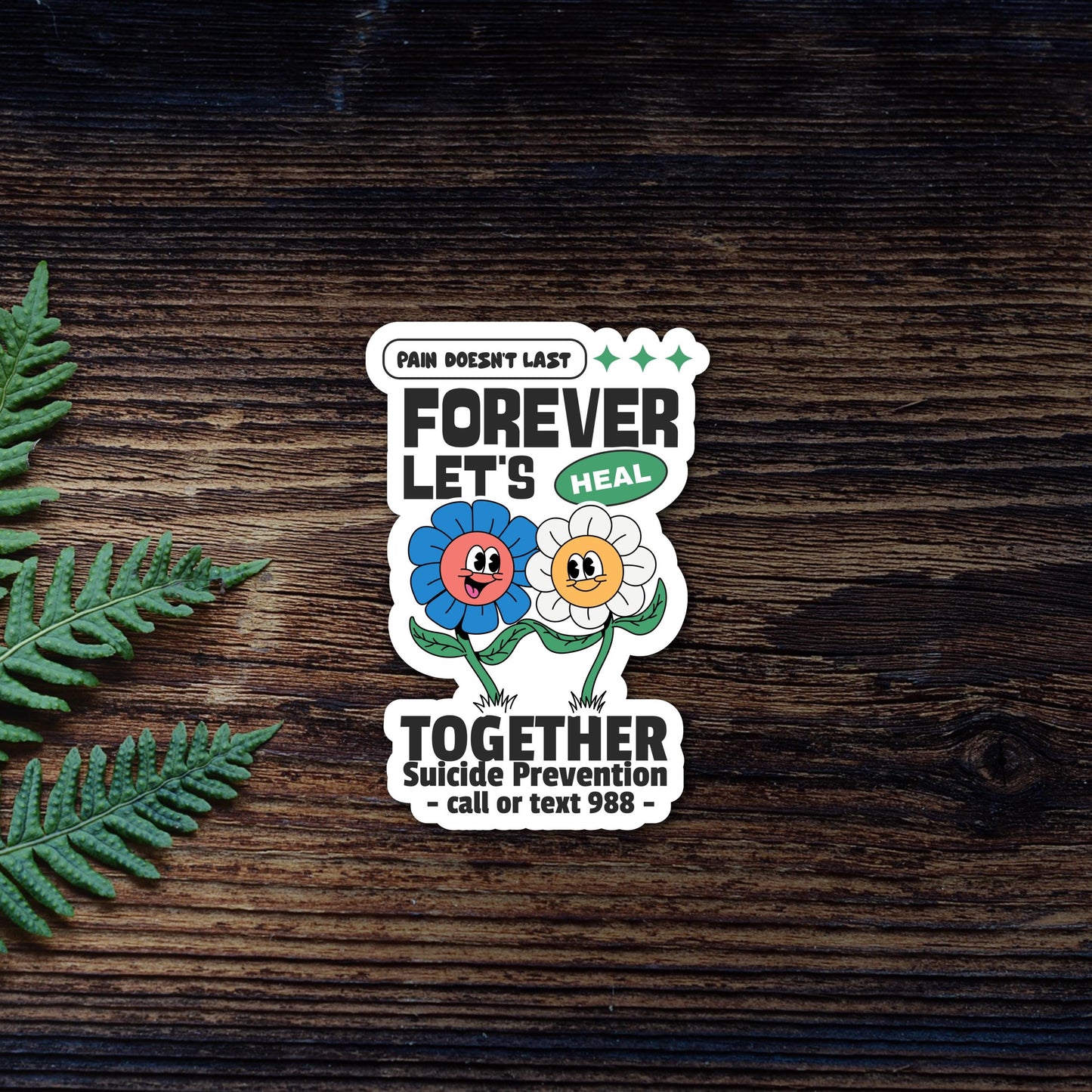 Suicide Prevention 988 Helpline Sticker - includes the call or text 988 on the bottom with white offset border around die cut sticker. Placed on dark wooden background.