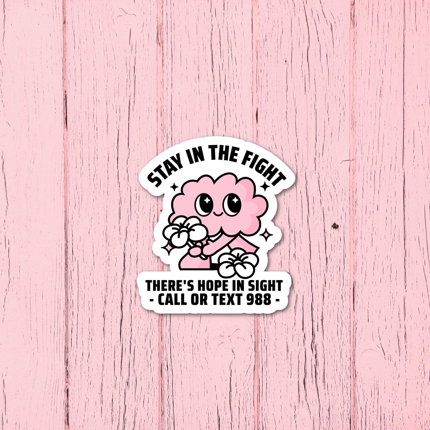 Suicide Prevention and Crisis Helpline Sticker - Call or Text 988 Suicide Prevention Sticker with Cute Pink Brain Design on pink wooden background. Front View.