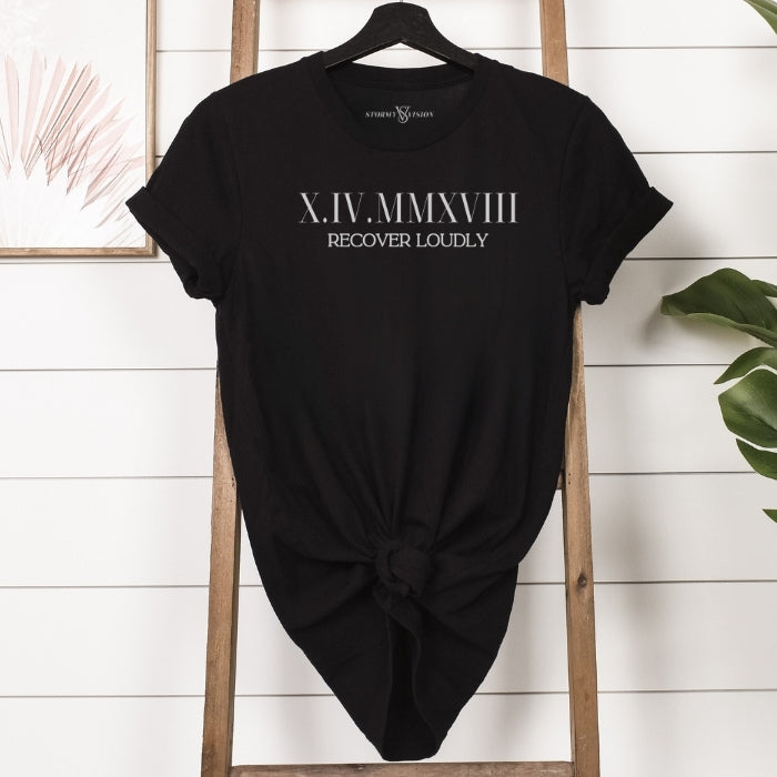 Customizable Roman Numeral Sobriety Unisex Shirt in Black hanging on ladder. Great for men or women in recovery.