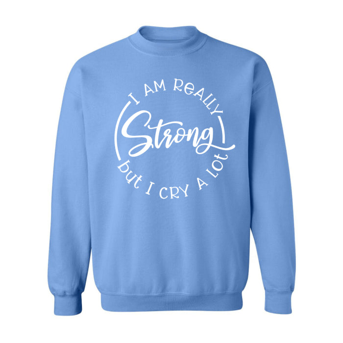 Cozy cute light blue sweatshirt with "Strong, but Cry A Lot" slogan, ideal for those who balance strength with vulnerability, perfect for winter days.