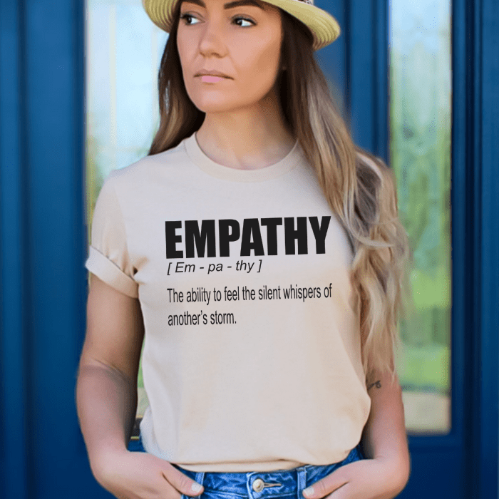 woman wearing a sand Empathy Definition Quote T-shirt with short sleeves