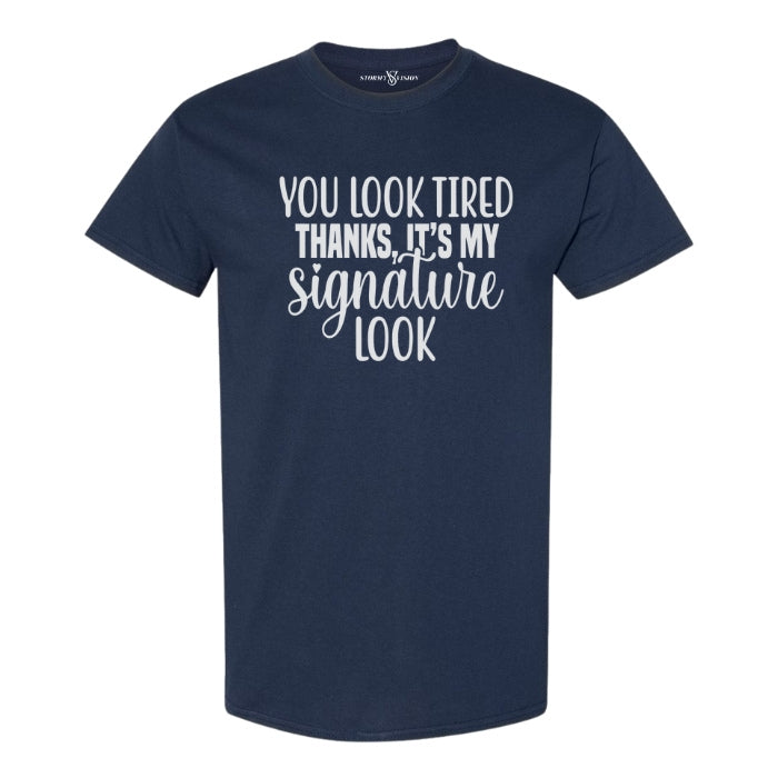 You Look Tired Sarcastic Mental Health T-shirt. Navy Blue short sleeve shirt frontal view on white background.