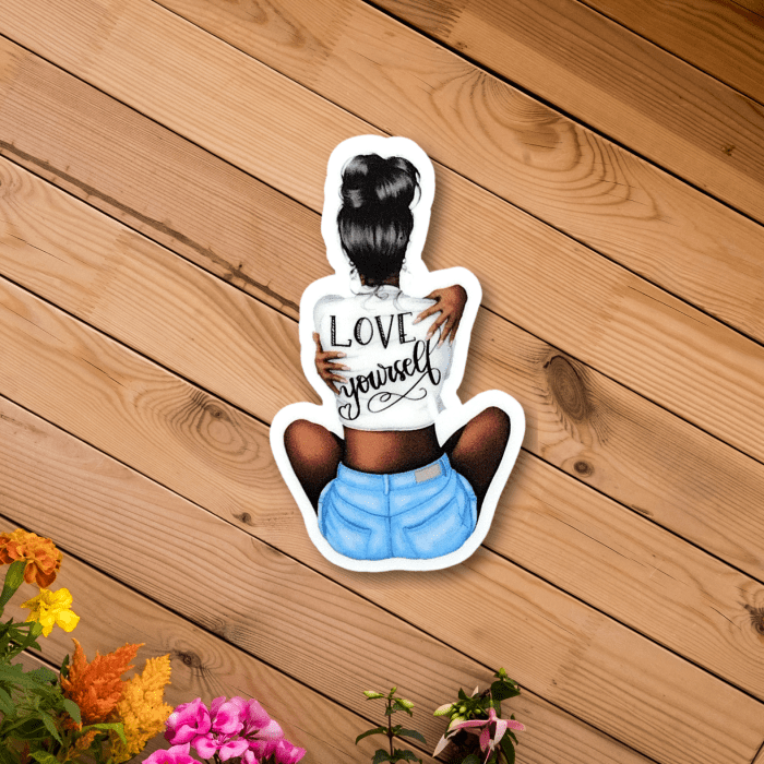 cute inspirational love yourself sticker of an women hugging herself - on a wooden background