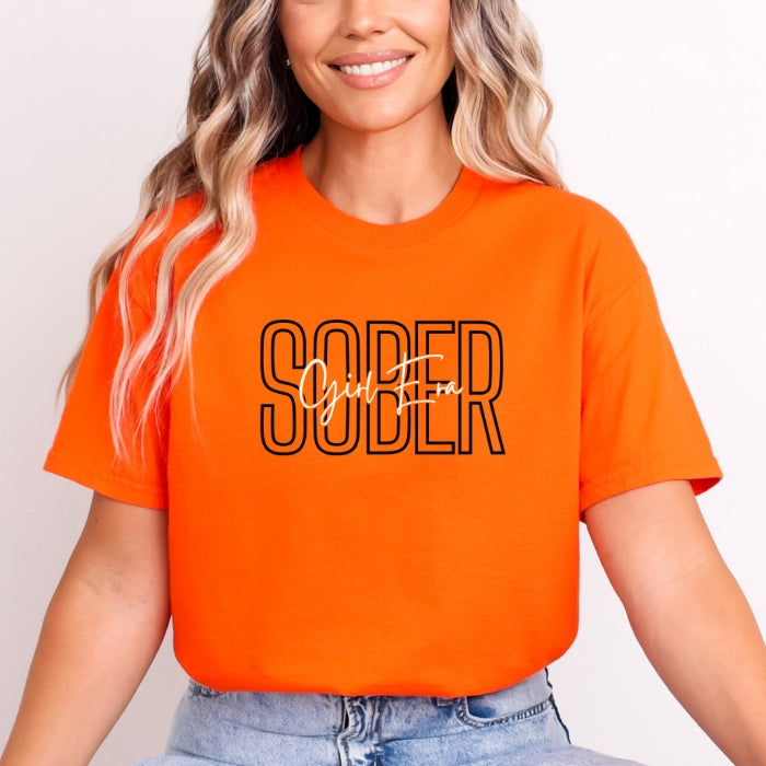 Sober Girl Era Orange Sobriety Tee For Women. Short Sleeve, Round Neck Tee with black and white font on white women. Front View.