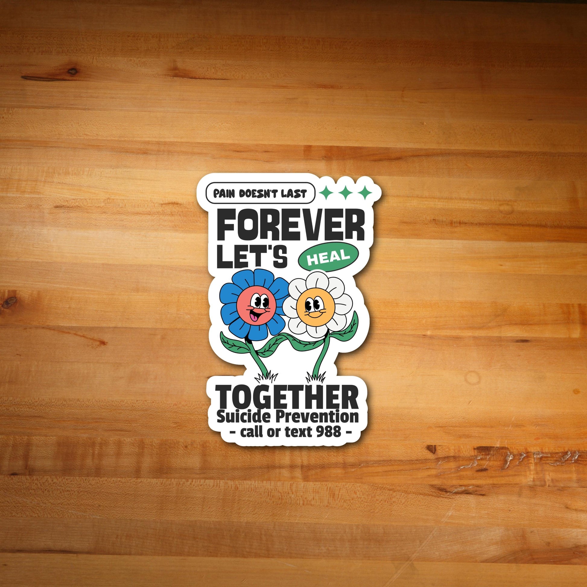 Suicide Prevention 988 Helpline Sticker  with Call or Text 988 at the bottom. Die Cut sticker is trimmed in white border placed on wooden background. 