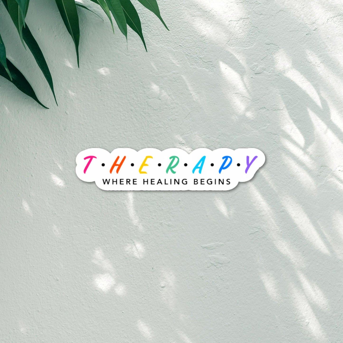 Therapy Where Healing Begins - Inspirational Sticker - Typography style sticker with multi-colors and white border placed on white textured background.
