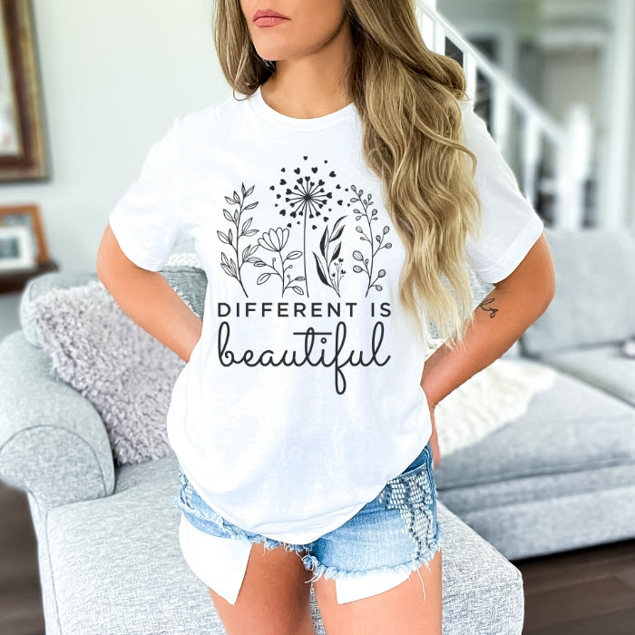 White floral graphic t shirt for women, showcased with an inspirational mental health "Different Is Beautiful" quote, ideal for women seeking empowering and motivational t shirts online.