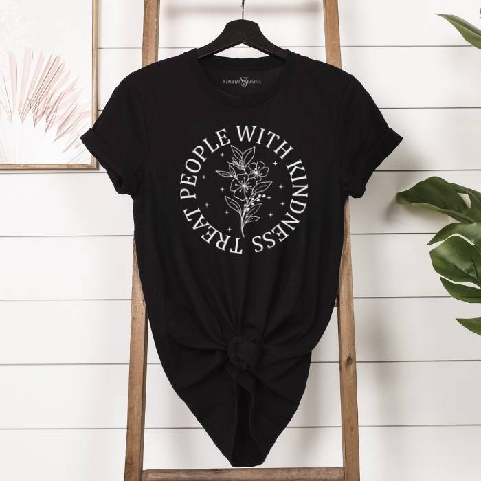 Classic black crew neck tee with a meaningful "Treat People With Kindness" slogan, in white with floral design. ideal for mental health advocates and behavioral health counselors.