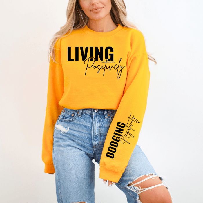 Gold and black long sleeve crew neck sweatshirt for women, featuring an uplifting message on the sleeves. great for seasonal layering, shop near me for this unique sweater.