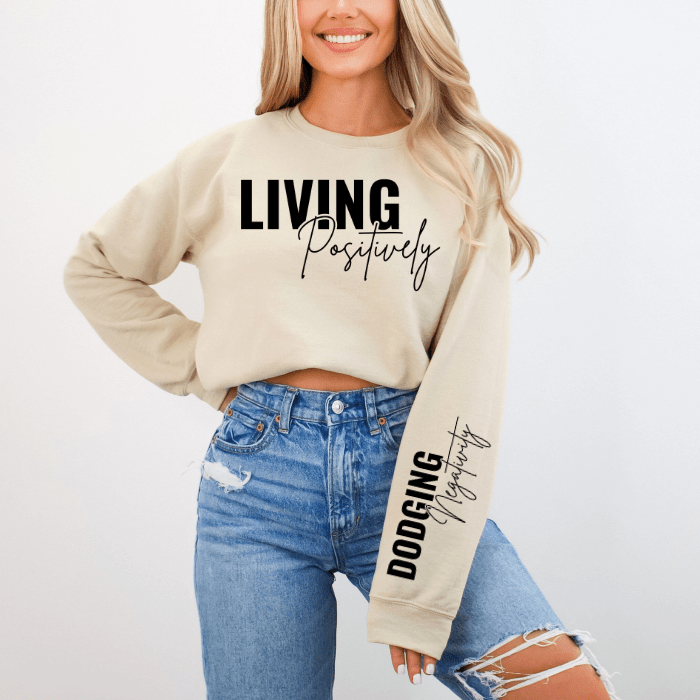 Positive Thinking Lifestyle Clothing - Women's plus size sand loose fit sweatshirt, showcasing positivity quote on chest and sleeve. pairs well with boots and jeans for a casual yet empowering look.